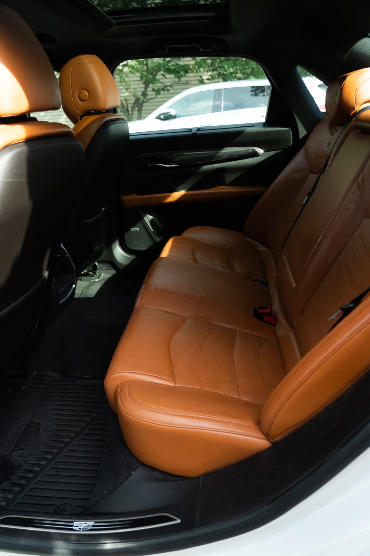 Restored tan leather rear seats inside a Cadillac CT6