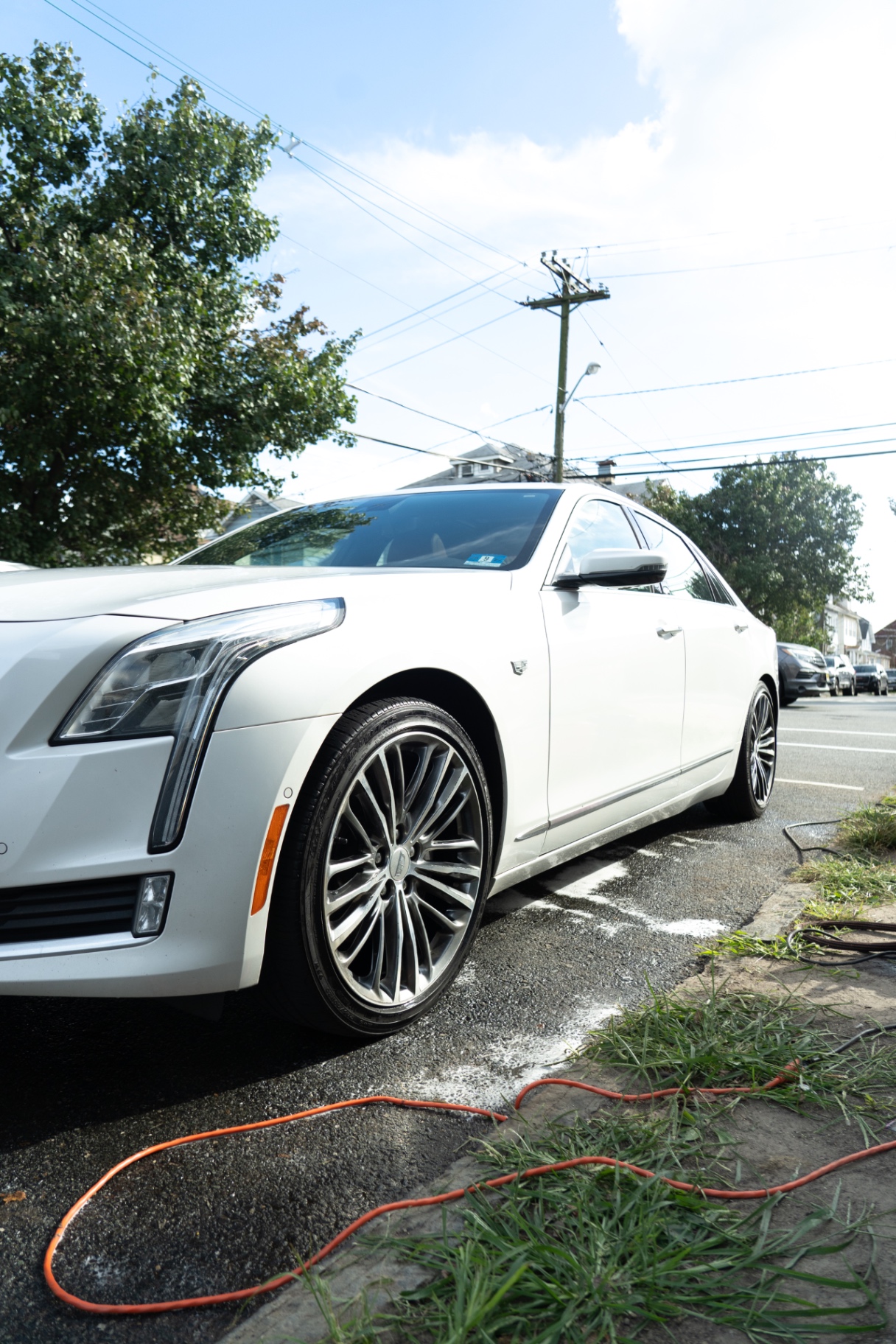 Freshly detailed white Cadillac CT6, front wheel and body