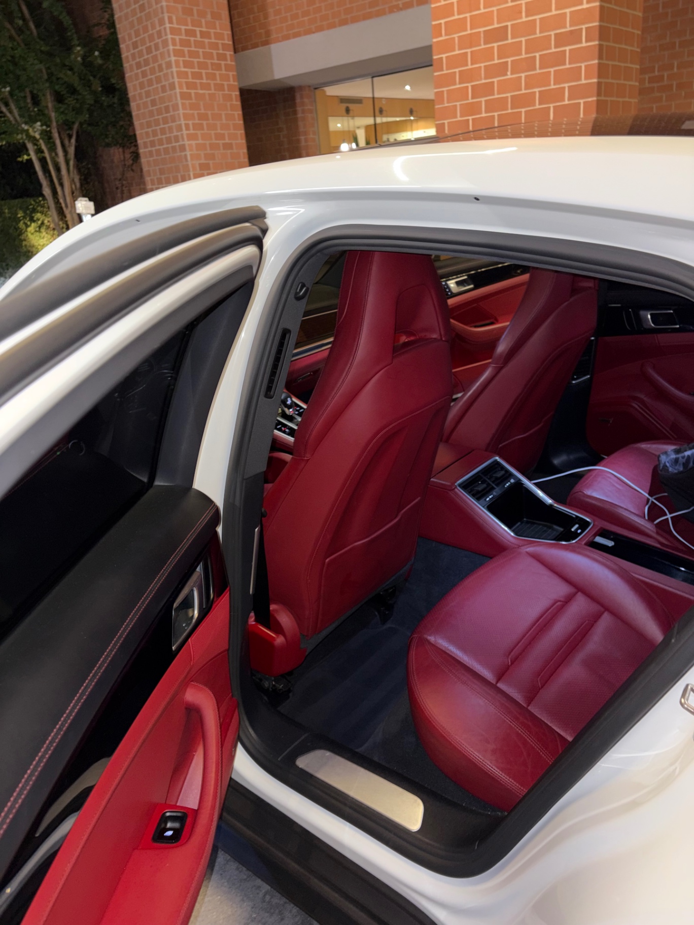Red leather Porsche Panamera seats through an open door